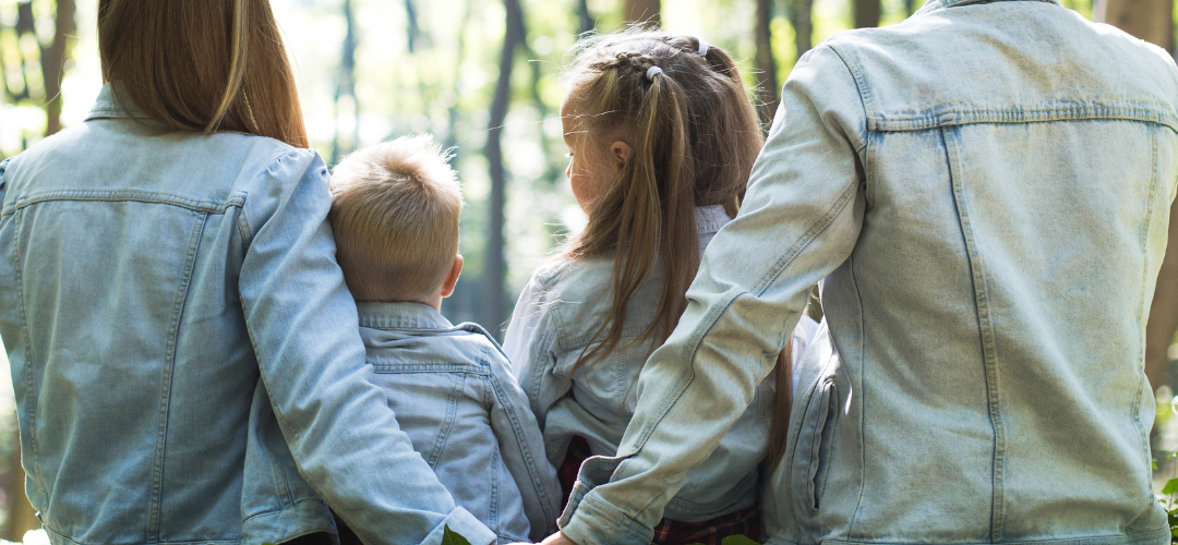 Image of family in a forest.